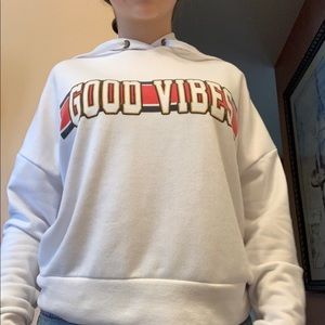 A white hoodie that says good vibes